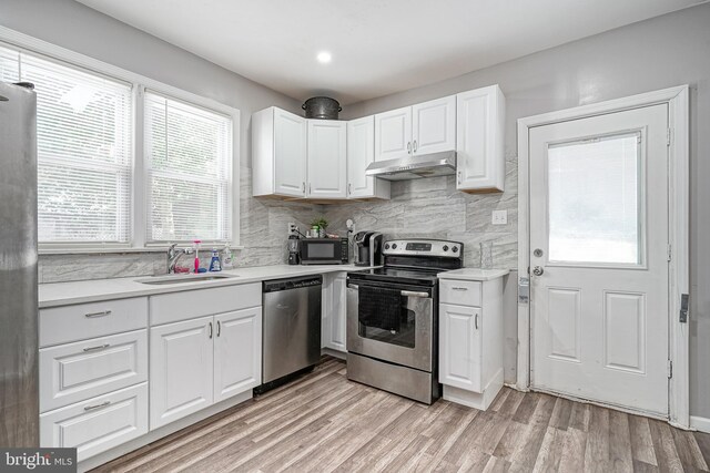 417 E Main St, Millville, NJ 08332 - kitchen with a sink, light countertops, under cabinet range hood, and stainless steel appliances