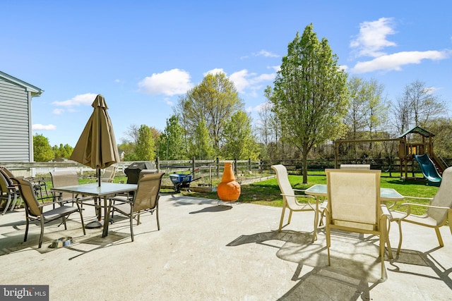 122 Abbigail Xing, Townsend, DE 19734 - view of patio featuring fence, outdoor dining space, and a playground
