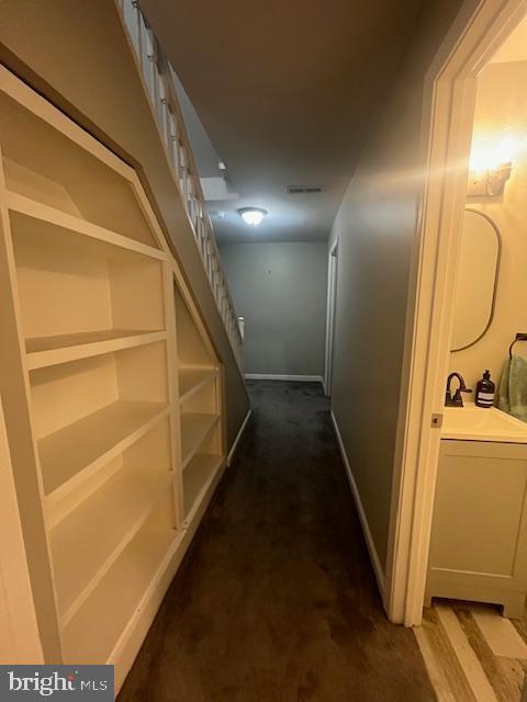 474 Colonial Ridge Ln, Arnold, MD 21012 - hallway with dark carpet and a sink