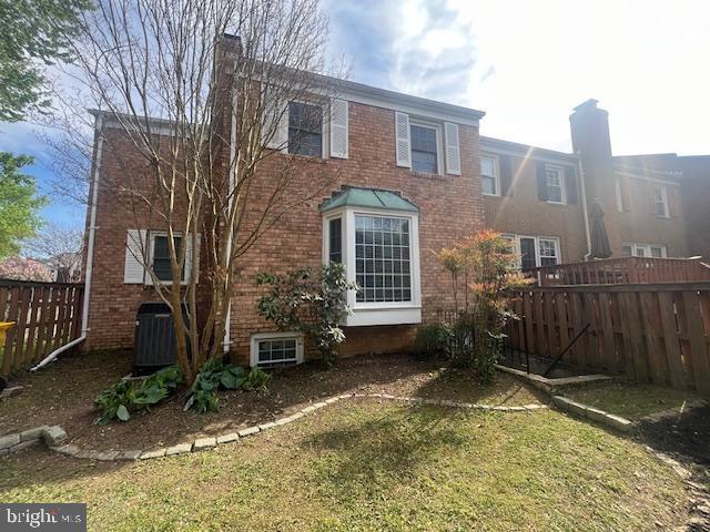 474 Colonial Ridge Ln, Arnold, MD 21012 - back of property featuring a chimney, brick siding, and central air condition unit