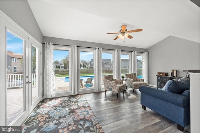 living room with a ceiling fan, vaulted ceiling, and a healthy amount of sunlight
