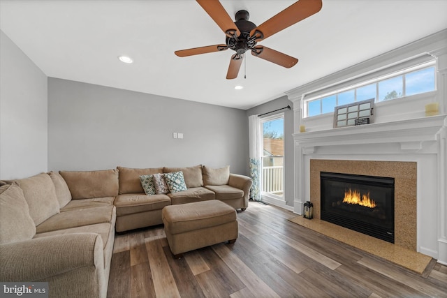 living area featuring wood finished floors, a fireplace, a ceiling fan, and recessed lighting