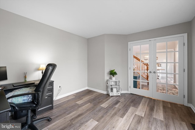 office space with french doors, baseboards, and wood finished floors