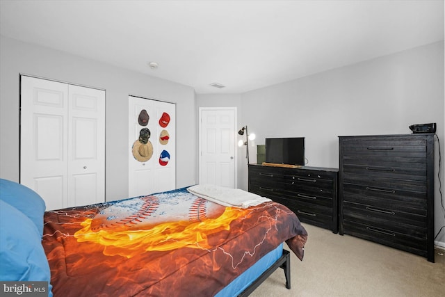bedroom with visible vents and light colored carpet