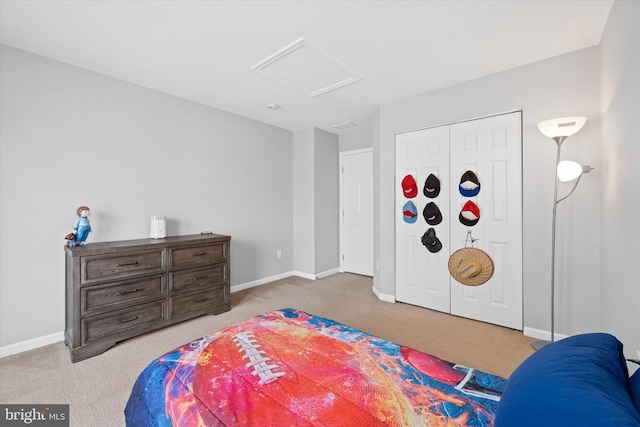 bedroom with carpet flooring, baseboards, and attic access