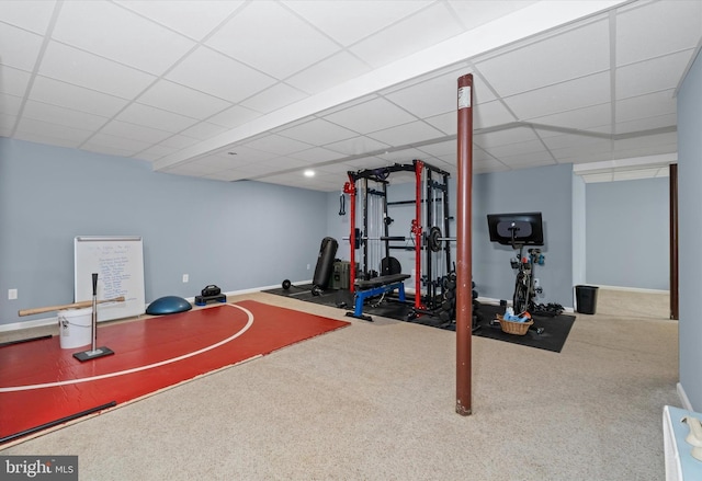 exercise room with carpet flooring and a drop ceiling