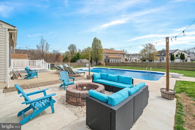 view of swimming pool with a fenced in pool, a residential view, an outdoor living space with a fire pit, a patio area, and a fenced backyard