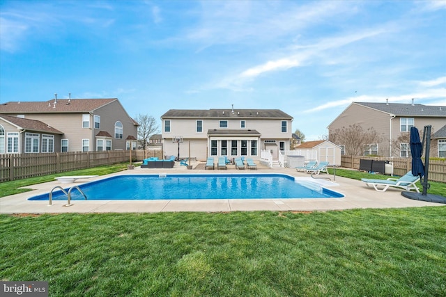 view of pool featuring an outdoor living space, an outbuilding, a fenced backyard, and a storage unit