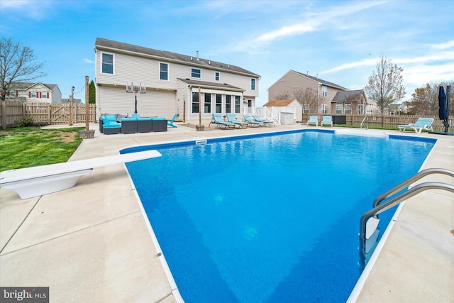 view of swimming pool featuring a fenced in pool, a patio area, a fenced backyard, and an outdoor hangout area