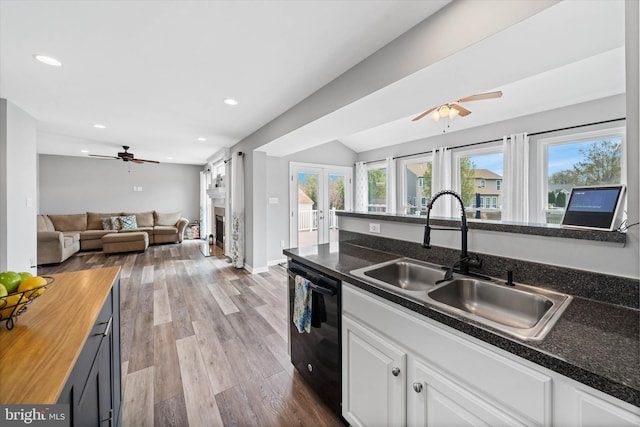 kitchen with recessed lighting, open floor plan, ceiling fan, dishwasher, and a sink