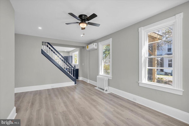 700 Pennsylvania Ave, Delanco, NJ 08075 - foyer entrance with radiator heating unit, wood finished floors, a wall unit AC, and stairway