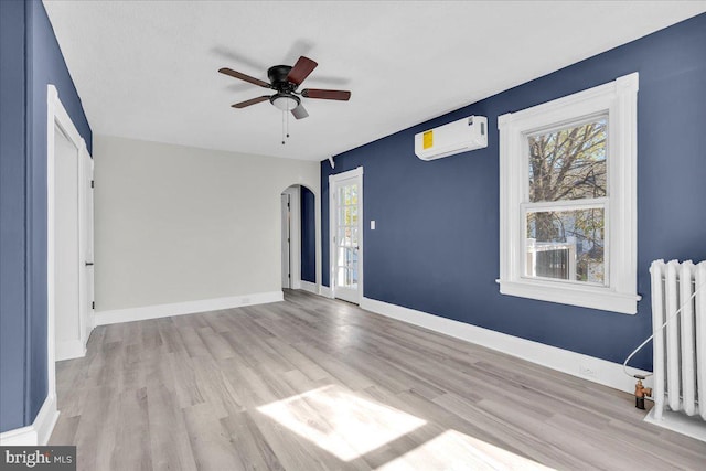 700 Pennsylvania Ave, Delanco, NJ 08075 - unfurnished bedroom with radiator heating unit, arched walkways, wood finished floors, and a wall mounted AC