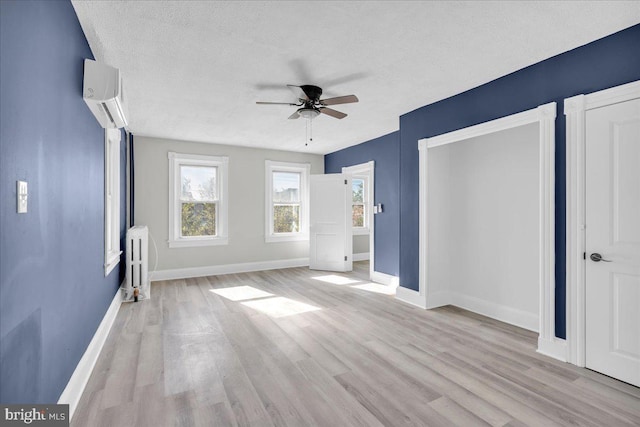 700 Pennsylvania Ave, Delanco, NJ 08075 - unfurnished bedroom with baseboards, radiator heating unit, light wood-style flooring, and a wall unit AC