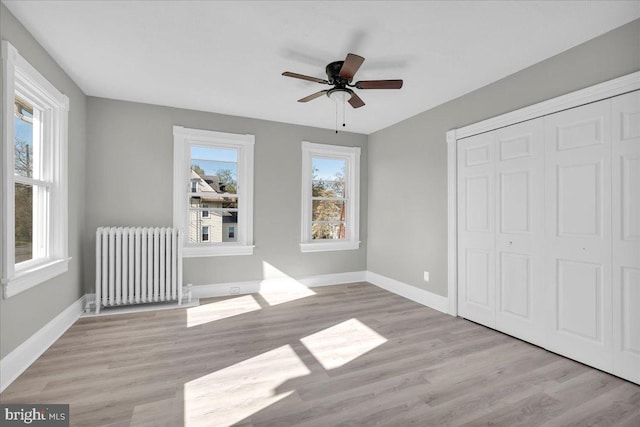 700 Pennsylvania Ave, Delanco, NJ 08075 - unfurnished bedroom with radiator, wood finished floors, and baseboards