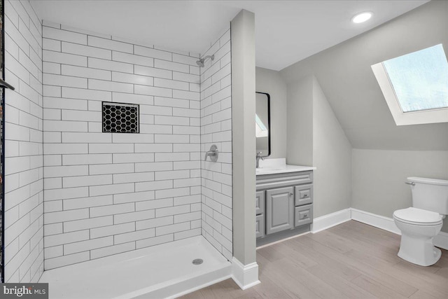 700 Pennsylvania Ave, Delanco, NJ 08075 - full bathroom with a tile shower, wood finished floors, toilet, vanity, and a skylight