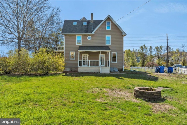 700 Pennsylvania Ave, Delanco, NJ 08075 - rear view of house with a chimney, fence, an outdoor fire pit, and a lawn