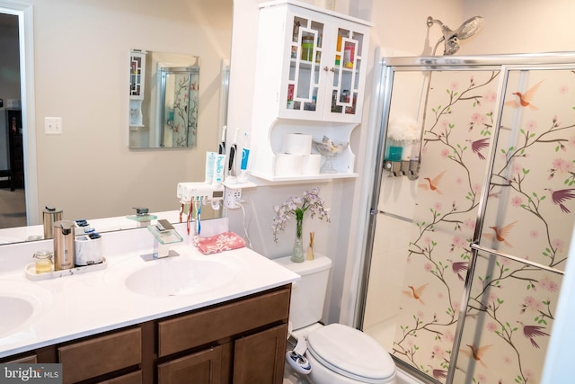 full bath with toilet, a stall shower, double vanity, and a sink