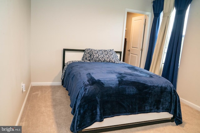 carpeted bedroom with baseboards