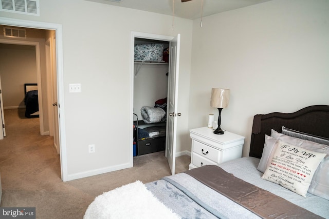 carpeted bedroom featuring a closet, visible vents, and baseboards