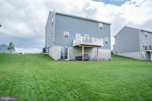 back of house featuring a lawn, a deck, and central air condition unit