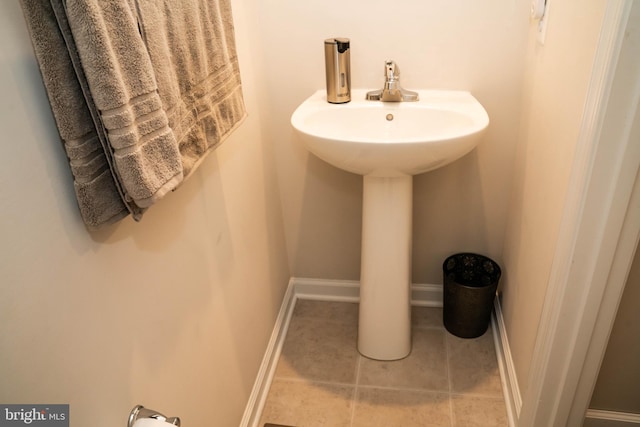 bathroom with tile patterned floors and a sink