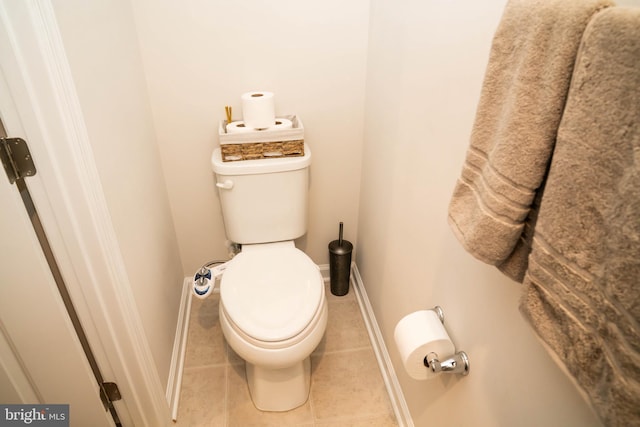 bathroom featuring tile patterned floors, toilet, and baseboards