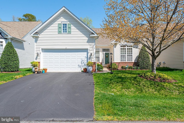 25 Easton Ave, Ocean Pines, MD 21811 - view of front facade featuring brick siding, a front lawn, a garage, and driveway