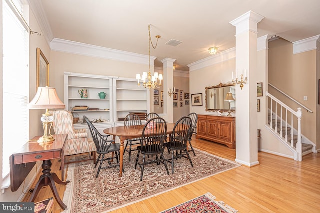 25 Easton Ave, Ocean Pines, MD 21811 - dining area featuring ornamental molding, decorative columns, a chandelier, and wood finished floors