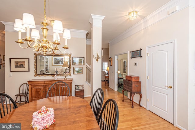 25 Easton Ave, Ocean Pines, MD 21811 - dining area with light wood finished floors, a notable chandelier, ornate columns, and crown molding
