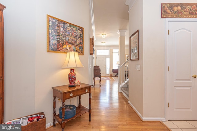 25 Easton Ave, Ocean Pines, MD 21811 - hall featuring light wood-style flooring, ornate columns, baseboards, and stairs