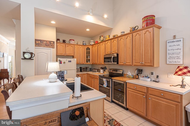 25 Easton Ave, Ocean Pines, MD 21811 - kitchen with glass insert cabinets, appliances with stainless steel finishes, light countertops, a sink, and beverage cooler