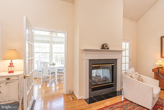 25 Easton Ave, Ocean Pines, MD 21811 - living area with light wood-style floors, high vaulted ceiling, a multi sided fireplace, visible vents, and baseboards