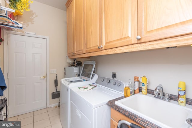 25 Easton Ave, Ocean Pines, MD 21811 - laundry area featuring light tile patterned floors, water heater, washing machine and dryer, a sink, and cabinet space