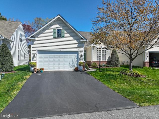 25 Easton Ave, Ocean Pines, MD 21811 - view of front facade featuring driveway, a garage, and a front lawn
