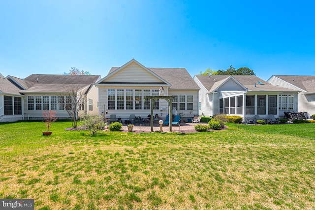 25 Easton Ave, Ocean Pines, MD 21811 - rear view of property with a sunroom, a patio area, and a lawn