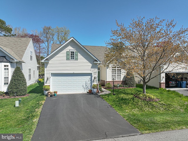 25 Easton Ave, Ocean Pines, MD 21811 - view of front facade featuring a front yard, roof with shingles, driveway, and an attached garage