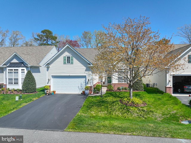 25 Easton Ave, Ocean Pines, MD 21811 - view of front of house with brick siding, roof with shingles, a front lawn, and aphalt driveway