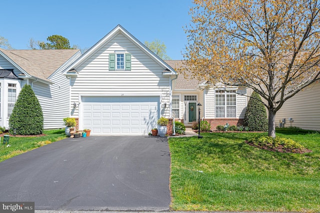 25 Easton Ave, Ocean Pines, MD 21811 - view of front of property with brick siding, a front lawn, an attached garage, and aphalt driveway