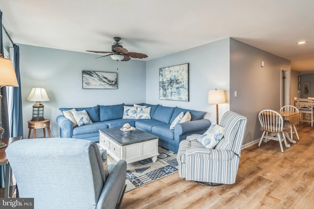 living room featuring recessed lighting, light wood-style floors, baseboards, and a ceiling fan