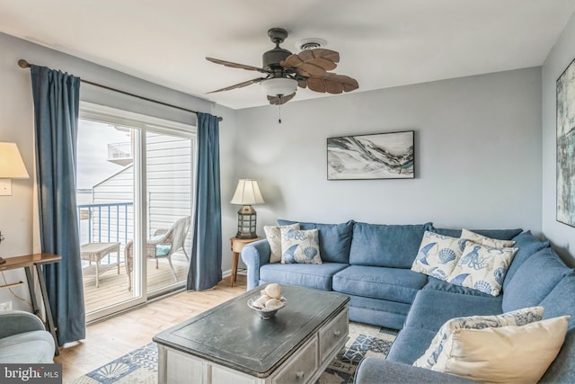 living room featuring light wood finished floors and a ceiling fan