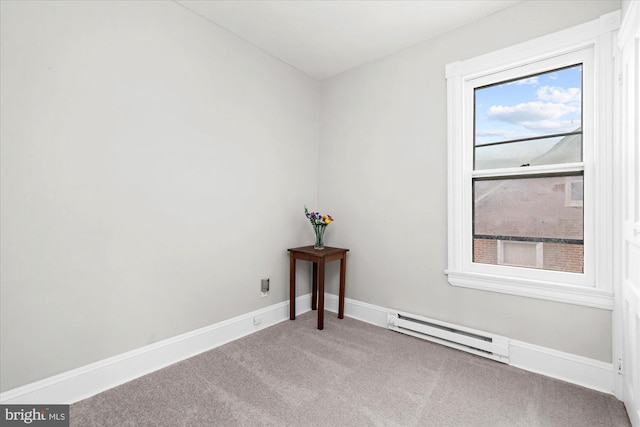 empty room featuring a baseboard radiator, baseboards, and carpet floors