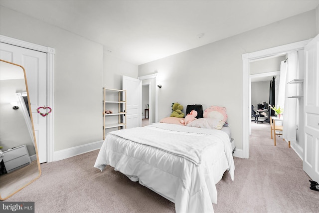 bedroom featuring baseboards and light colored carpet