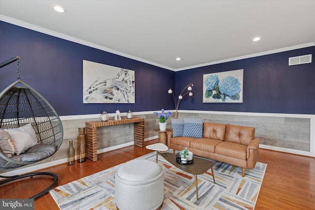 living area with ornamental molding, visible vents, recessed lighting, and wood finished floors