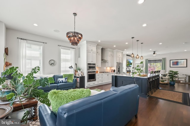 living room with recessed lighting and dark wood finished floors