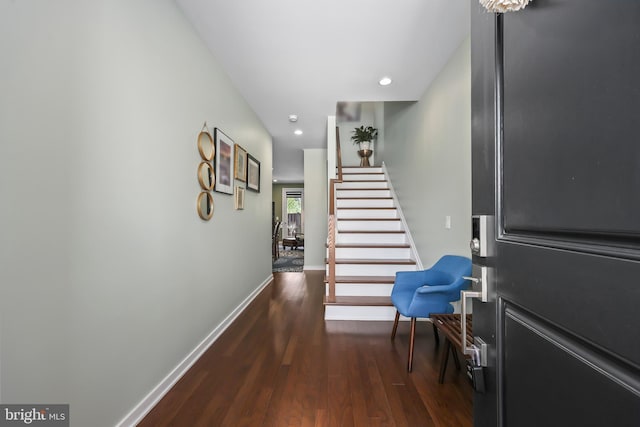 interior space featuring recessed lighting, baseboards, wood finished floors, and stairway