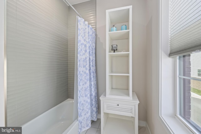 bathroom with tile patterned floors and shower / bath combo