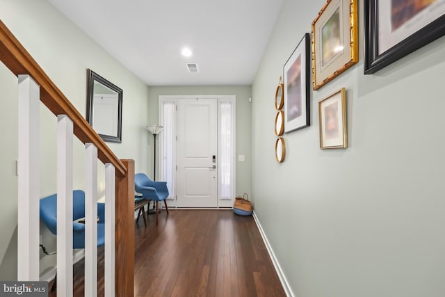 entryway featuring stairs, dark wood-style flooring, baseboards, and visible vents