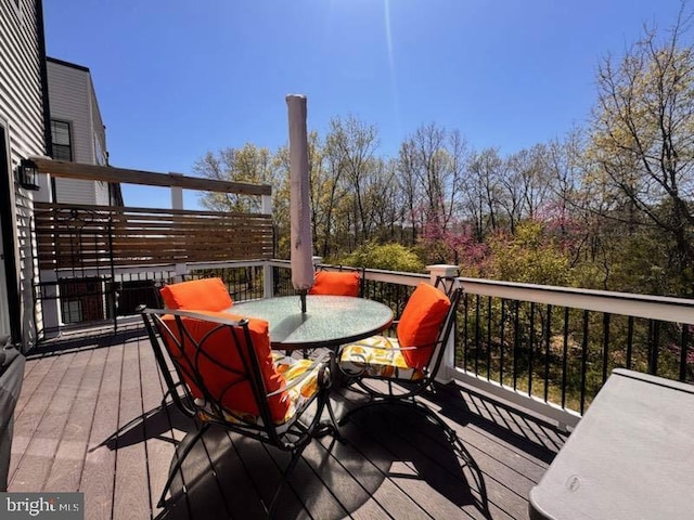 wooden deck featuring outdoor dining space