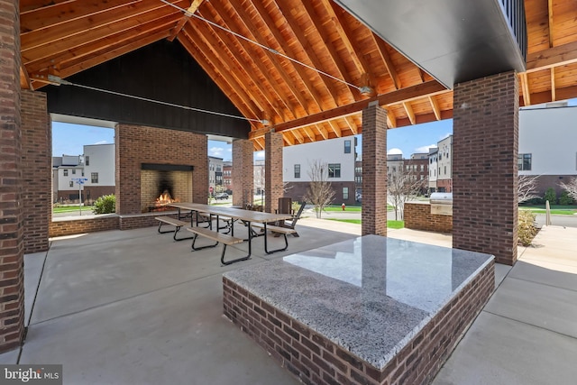 view of patio / terrace featuring an outdoor brick fireplace
