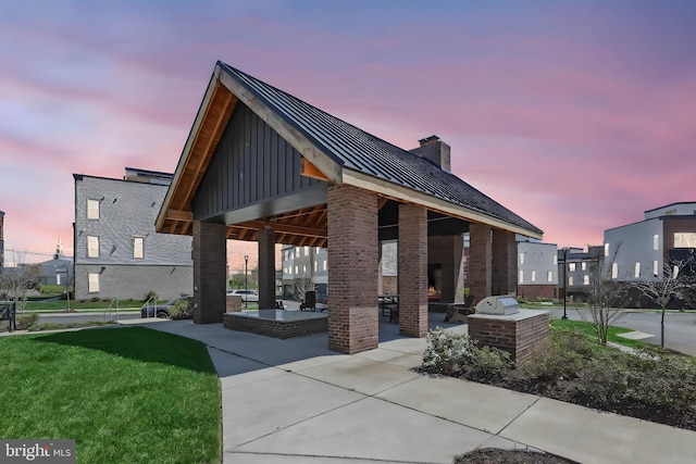 view of community with a gazebo, a yard, exterior kitchen, and a patio area